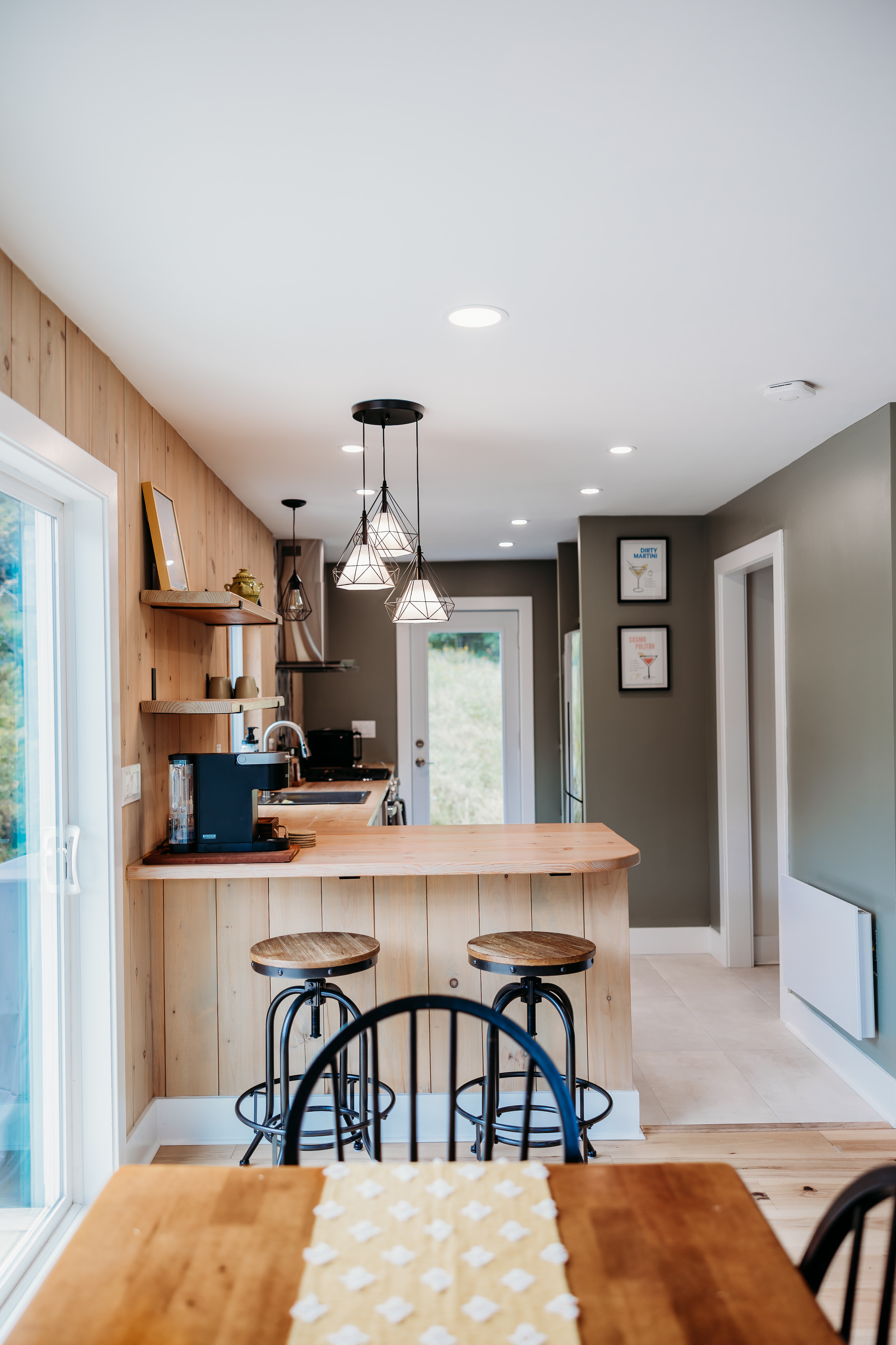 Kitchen bar with wood paneling and pendant lights